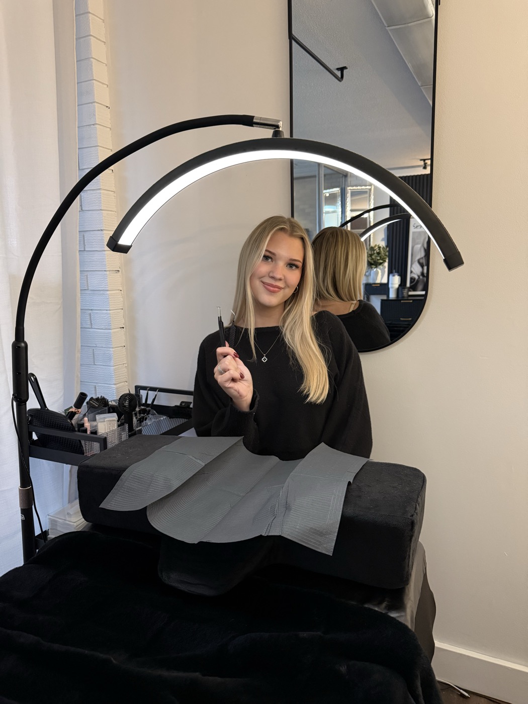 Abby at her lash bed under the lash lamp